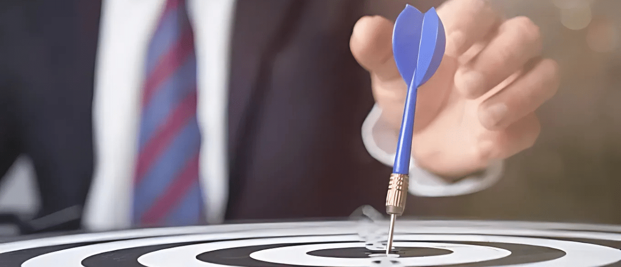 Precision Targeting for Law Firm Client Acquisition with Direct Mail A close-up of a blue dart hitting the bullseye of a target, with a blurred person in a suit in the background, symbolizing precise and targeted client acquisition for law firms.